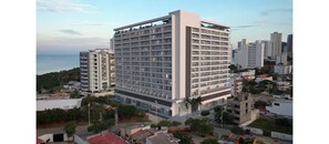 A multi-story hotel with a modern design, featuring a large number of rooms and a central courtyard.
