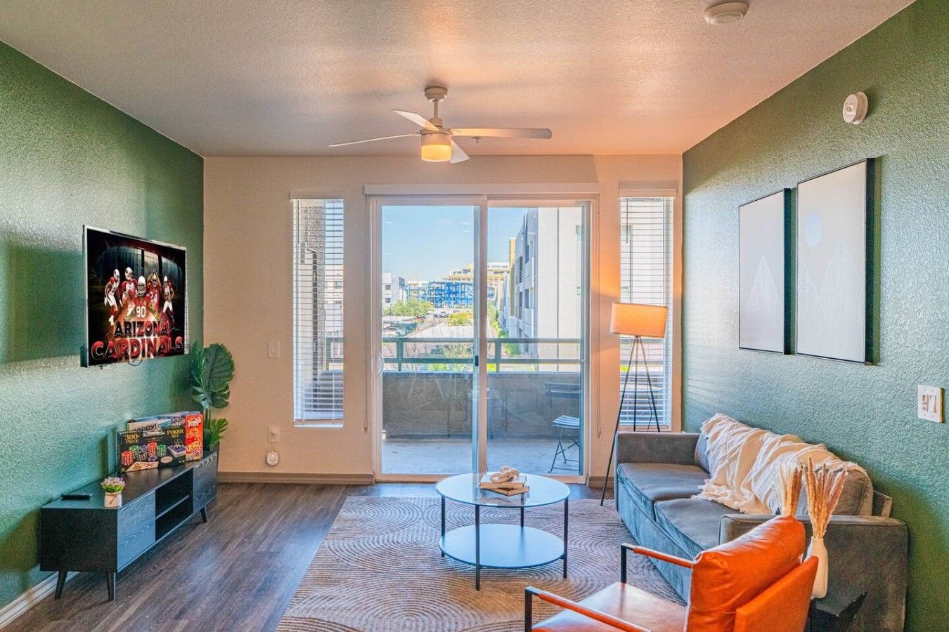 A modern living room with a sofa, coffee table, and a TV on the wall.