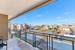 A balcony with a clear view of a parking lot and buildings. - Stadium Area Unit w/ Balcony,Pool,Gym,Parking,W/D (Glendale)