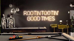 A pool table with billiard balls, a neon sign reading "ROOTIN' GOOD TIMES", and two metallic figures. - HeatedPool PickleBall Basktball Golf FirePit Games (San Antonio)