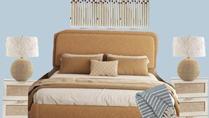 A bedroom with a beige upholstered headboard, two bedside tables with lamps, a bed with multiple pillows, and a decorative wall hanging above the bed. - 3-bedroom townhome in Atlanta near entertainment attractions (Atlanta)