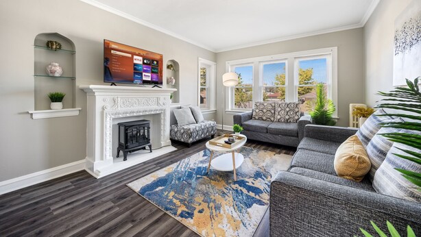 A living room with a fireplace, a television, and a sofa. - Serene Suburban Stay: Family-Friendly w/EZ Parking (Berwyn)