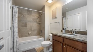 A bathroom with a bathtub, toilet, and sink. - Chic Elevator Apt mins to DT, Train, Dining & Hosp (Berwyn)
