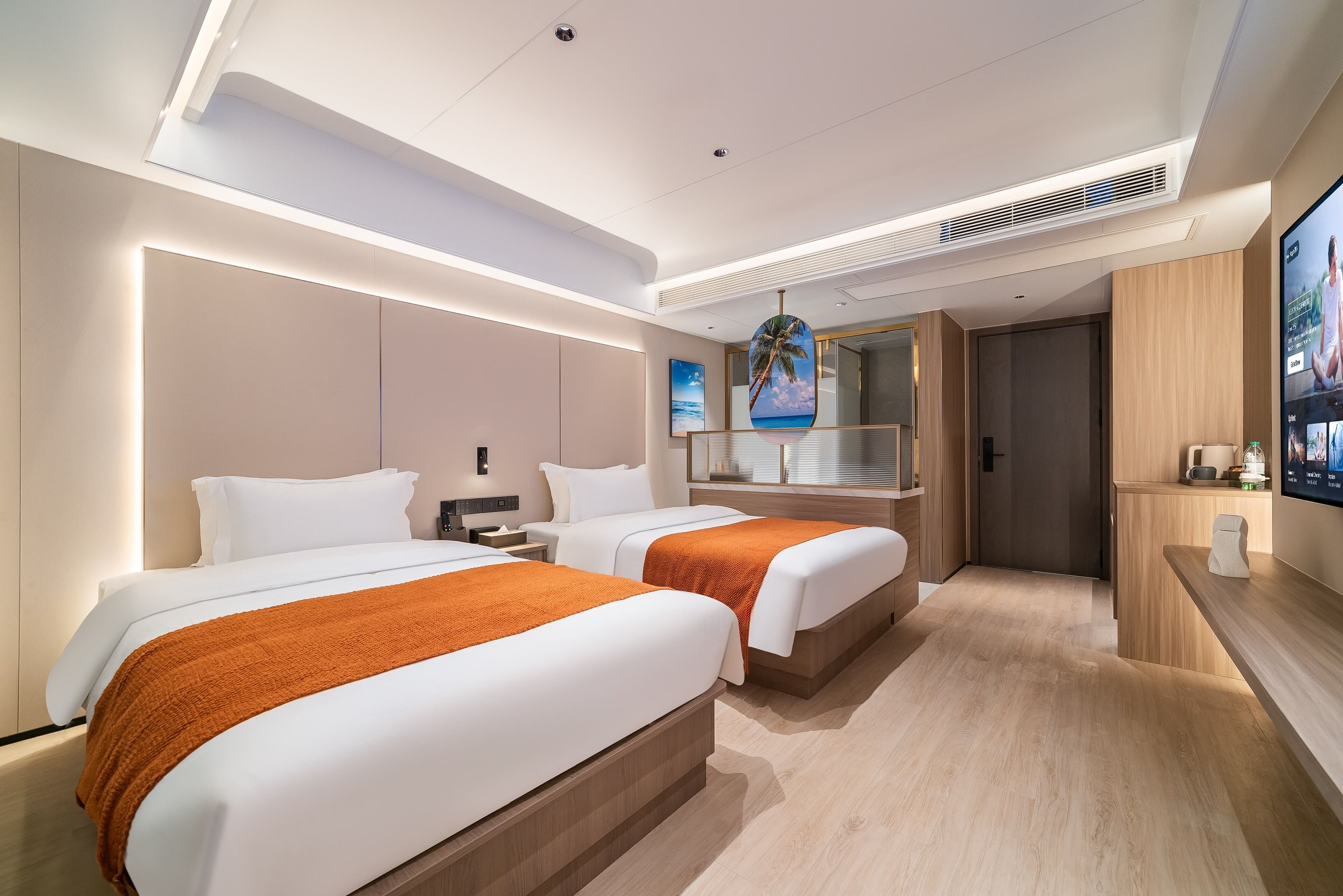 A modern hotel room with two beds, a large mirror, a TV, and a wooden floor.