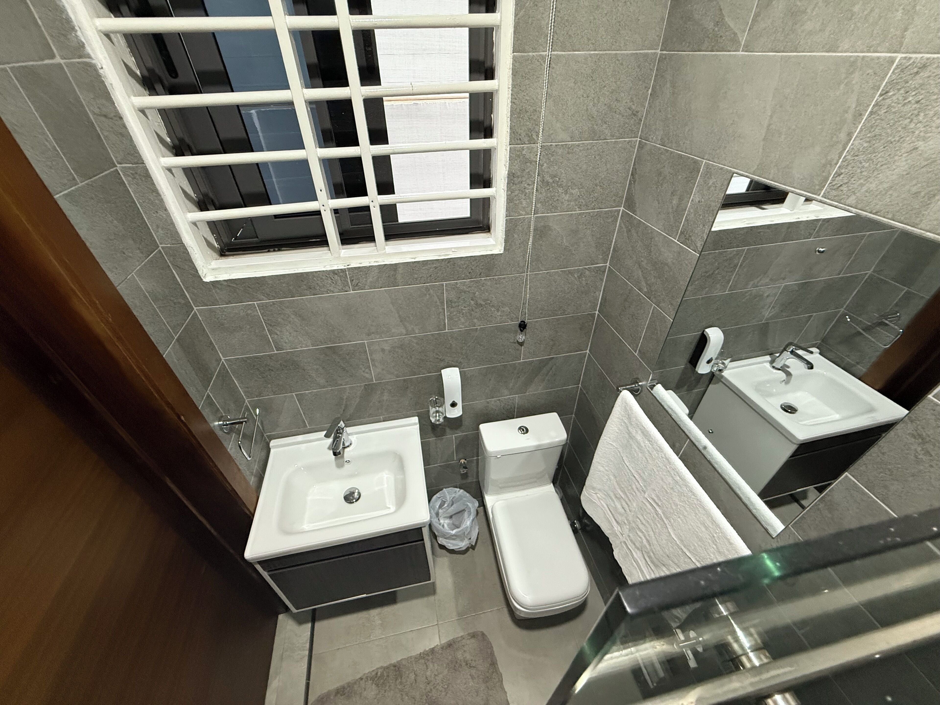 A modern bathroom with a toilet, sink, and bidet.