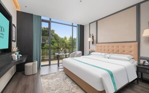 A hotel room with a large bed, a TV, a balcony with a view, and a desk with a lamp. - Xana Hotel Guilin Wuyue Square  Branch (Guilin)