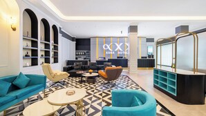 A modern hotel lobby with a geometric patterned floor, seating areas, and a reception desk. - Xana Hotel Guilin Wuyue Square  Branch (Guilin)