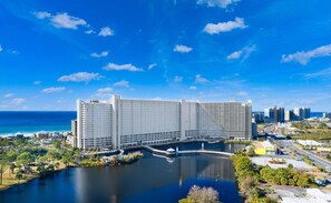 A large hotel with multiple high-rise buildings, a marina, and a view of the ocean and city skyline. - Beach Getaway Gulf View Condo | Sleeps 8 | Resort (Panama City Beach)