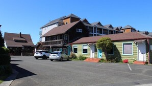 A row of two-story houses with a parking lot in front.