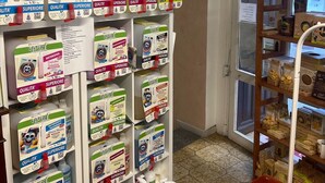 A retail store with shelves stocked with cleaning products and packaged goods. - The House of Anastasia (Taino)