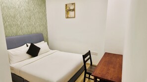 A bed with a headboard, a bedside table, and a wall-mounted artwork. - Eaton Residence KLCC - JD Home Stay | Two Bedroom Apartment with KLCC view (Kuala Lumpur)