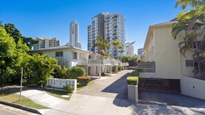 A residential area with modern buildings, a gated entrance, and a clear sky. - 300m to Beach • Surfers Paradise • 3 Beds (Surfers Paradise)