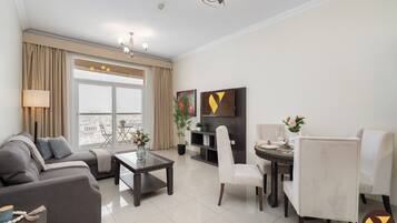 Luxury Apartment, Balcony, City View | Living area | 65-inch Smart TV with cable channels