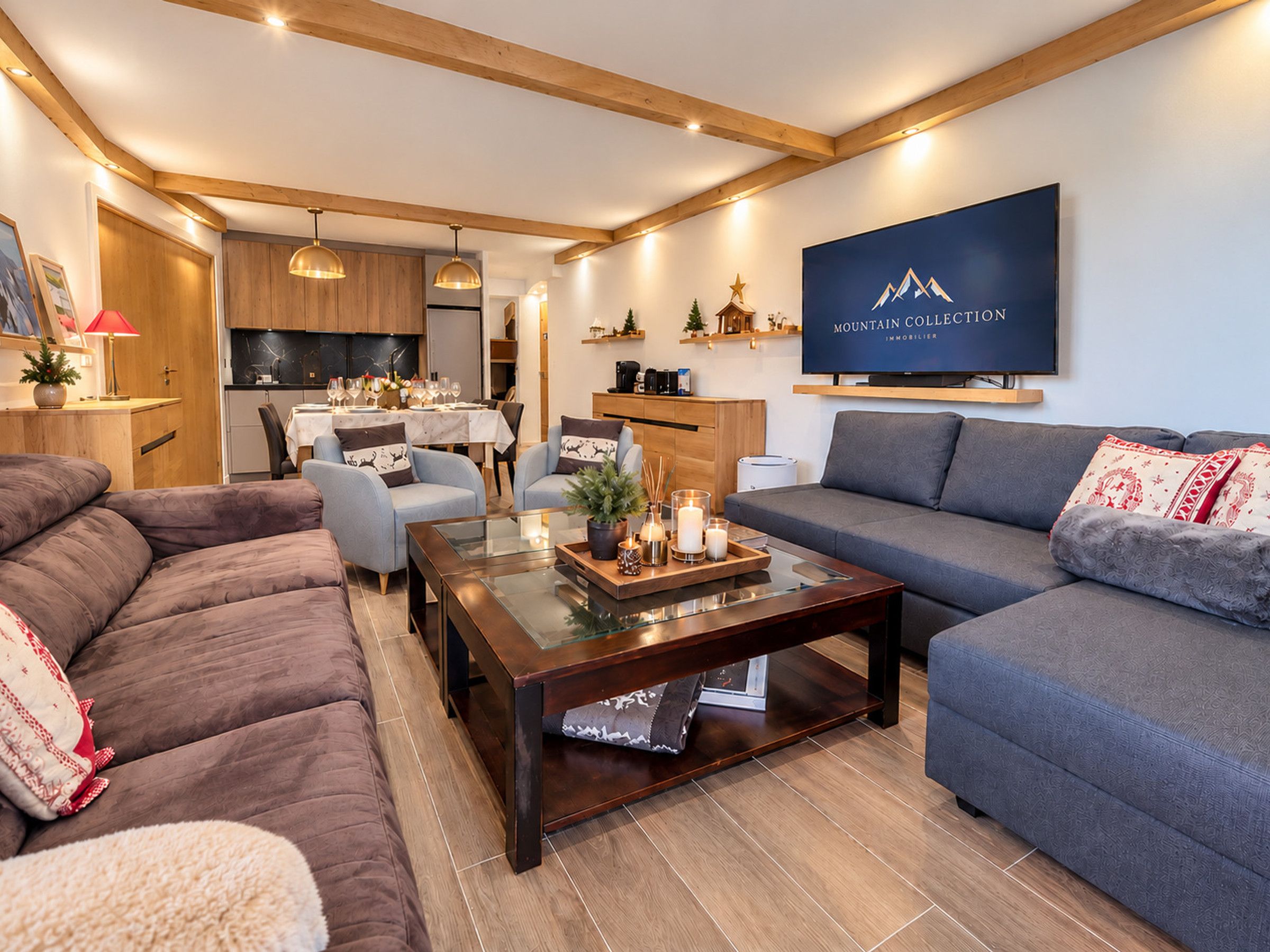 A modern living room with a sofa, armchair, and a coffee table with decorative items.