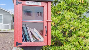 A red bookcase with a sign reading "Little Free Library" and books inside. - NEW LISTING! Rehoboth by the Sea - Ocean Block - 19 Cullen St (Dewey Beach)