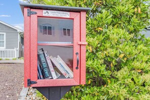 A red bookcase with a sign reading "Little Free Library" and books inside. - NEW LISTING! Rehoboth by the Sea - Ocean Block - 19 Cullen St (Dewey Beach)