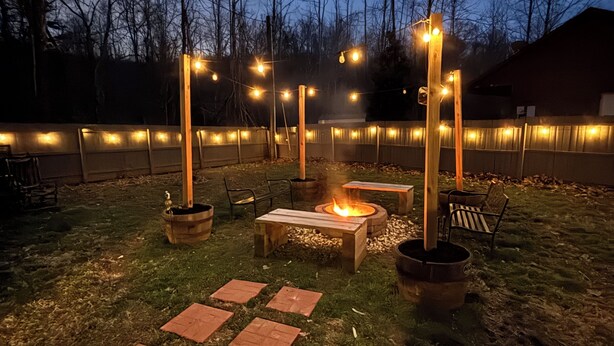 An outdoor patio area with a fire pit, seating, and string lights. - Updated - 3-bedroom house in delightful Sevierville, hot tub, dog friendly (Sevierville)