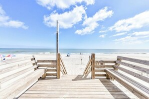 A wooden boardwalk leading to a beach with a wooden post marked "11" and a sandy beach in the background. - 4 Bedroom, 2nd Row, Shared Pool - Ocean Quarters A - River To Sea (Surfside Beach)