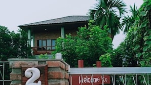 A brick pillar with the number 2 and a sign that reads "Welcome to Boa Guesthouse". - Bua Guest House (Medan)