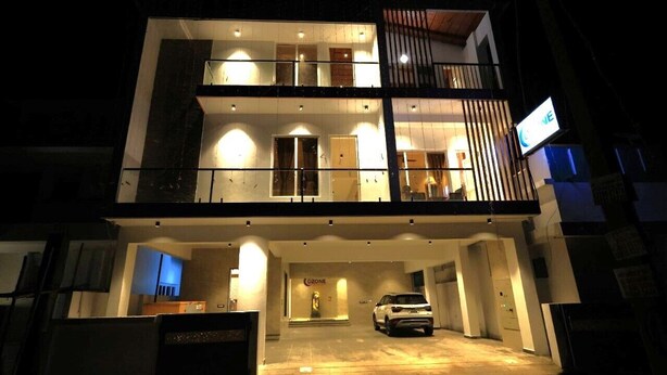 A two-story building with a car parked in the driveway. - Ozone Hill Resorts (Yercaud)