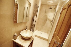 A modern bathroom with a large sink, a mirror, a shower, and a toilet. - 4 Bed in Mumbles (oc-hh53) (The Mumbles)