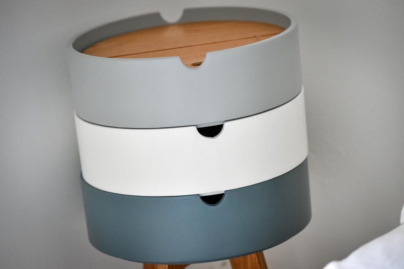 A cylindrical object with three horizontal sections, each with a different color.