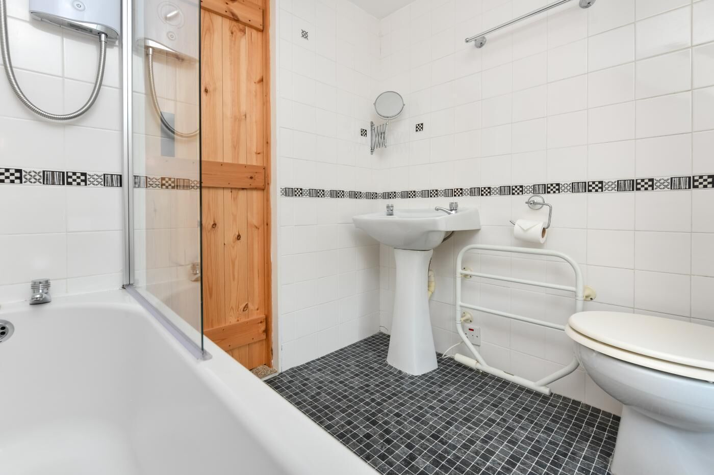 A bathroom with a bathtub, a sink, and a toilet.