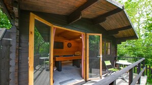 A wooden cabin with an open door leading to a deck area. - 4 Bed in New Quay (oc-bow272) (New Quay)