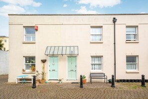 A two-story building with a flat facade, two doors, and a small window. - 2 Bed in Brighton (oc-bbivy2) (Hove)