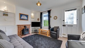 A cozy living room with a fireplace, a television, and comfortable seating. - 2 Bed in Deal (oc-cc0163) (Kingsdown)