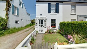 A white two-story house with a small front garden and a gravel driveway. - 2 Bed in Deal (oc-cc0163) (Kingsdown)
