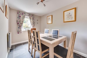 A dining room with a wooden table and chairs, a radiator, and two framed pictures on the wall. - 1 Bed in Elton (oc-dctco) (Elton)