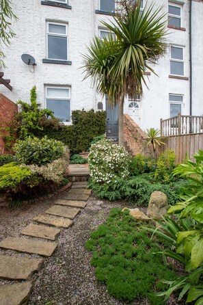 A garden pathway leading to a white building with multiple windows and a door. - 3 Bed in Scarborough (oc-s113) (Scarborough)