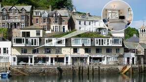 A waterfront building with multiple stories, including shops on the ground floor. - 1 Bed in West Looe (oc-1west) (Looe)