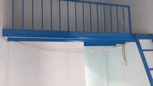 A blue staircase with a handrail leading to a landing. - A House In Binh Chanh, 1 Bedroom and 1 Bathroom (Thành phố Hồ Chí Minh)