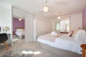 A bedroom with a bed, a desk, a chair, a mirror, and a radiator. - 6 Bed in Machynlleth (oc-bow374) (Glantwymyn)
