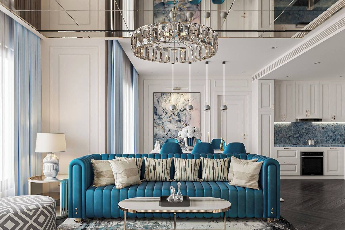 A modern living room with a blue sofa, a round coffee table, and a chandelier.