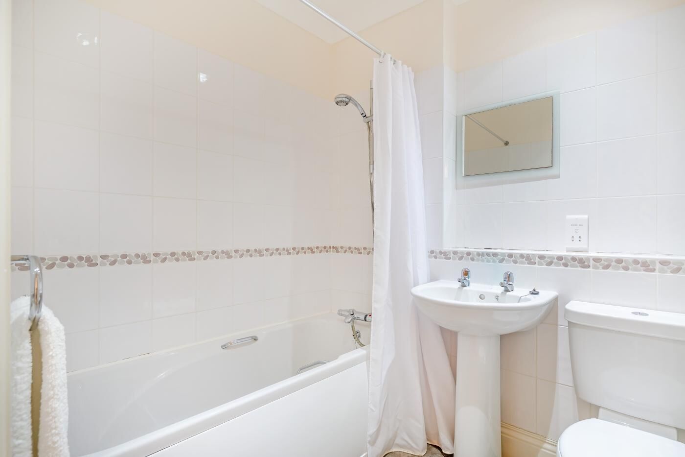 A bathroom with a bathtub, a sink, and a toilet.
