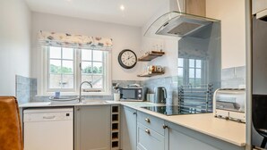 A modern kitchen with a dishwasher, a sink, a microwave, and a toaster. - 2 Bed in Allerford (oc-r29129) (Allerford)