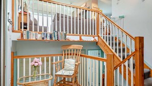 A staircase with wooden railings and a chair with a cushion. - 3 Bed in Mynytho (oc-m29517) (Mynytho)