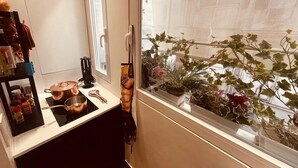 A kitchen with a window view of a balcony, a countertop with pots, a knife block, and a shelf with spices. - NEW! Nice apartment 2 steps from villa Borghese and Spanish Steps (Roma)