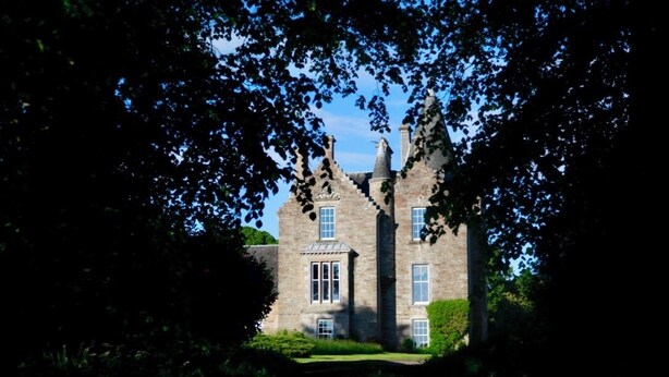 A stone building with multiple windows and a central entrance, surrounded by greenery. - 4 Bed in Cardross (oc-t30303) (Cardross)