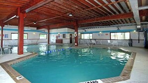 An indoor swimming pool with a wooden ceiling, clear water, and white poolside chairs. - Club Ocean Villa II 119 (Ocean City)