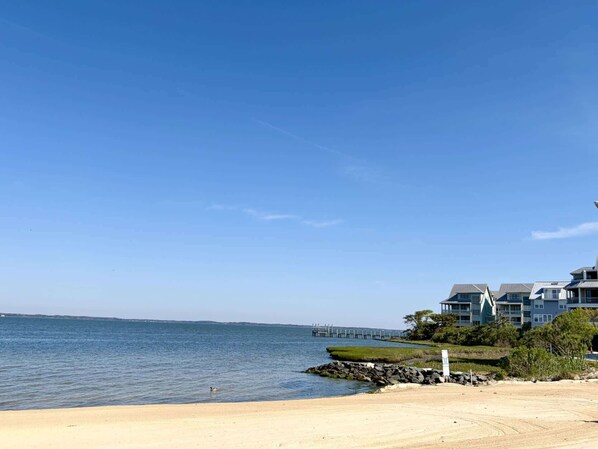 A coastal hotel with a view of the sea, a sandy beach, and a pier in the distance. - 6 Corner Store Ln (Ocean City)