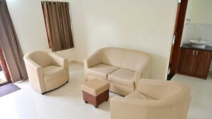 A living room with a sofa set, a coffee table, and a side table. - Bricknest Homes (Mysore)