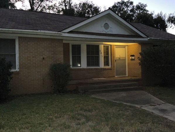 A single-story house with a front porch, a door, and a small window. - Cozy Three Bedroom House In Scenic Rusk. (Rusk)