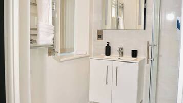Shower, hair dryer, towels, shampoo