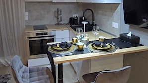 A modern kitchen with a central island, pendant lights, and bar stools. - Beach Studio, Nice, France (Nice)