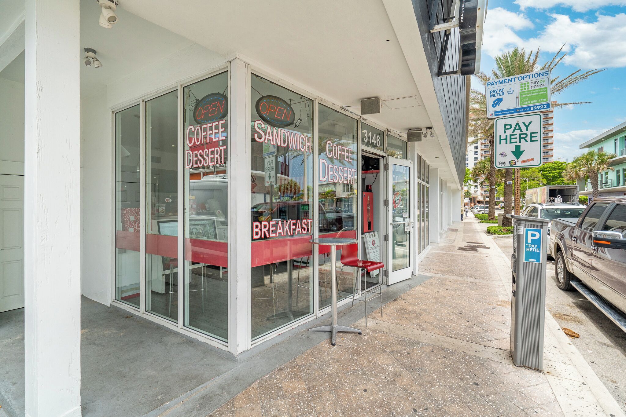 A storefront with signs for 'Coffee Dessert', 'Sandwich', and 'Breakfast'.