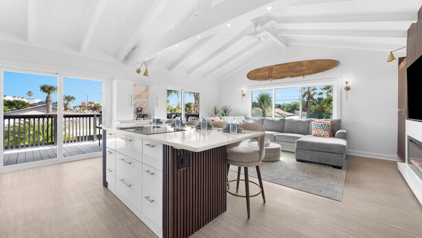 A spacious living area with a large island, a sofa, and a TV. - Private Pool/Spa! 4 Min Walk to Vilano Beach. Two Living Rooms & Kitchens (St. Augustine)